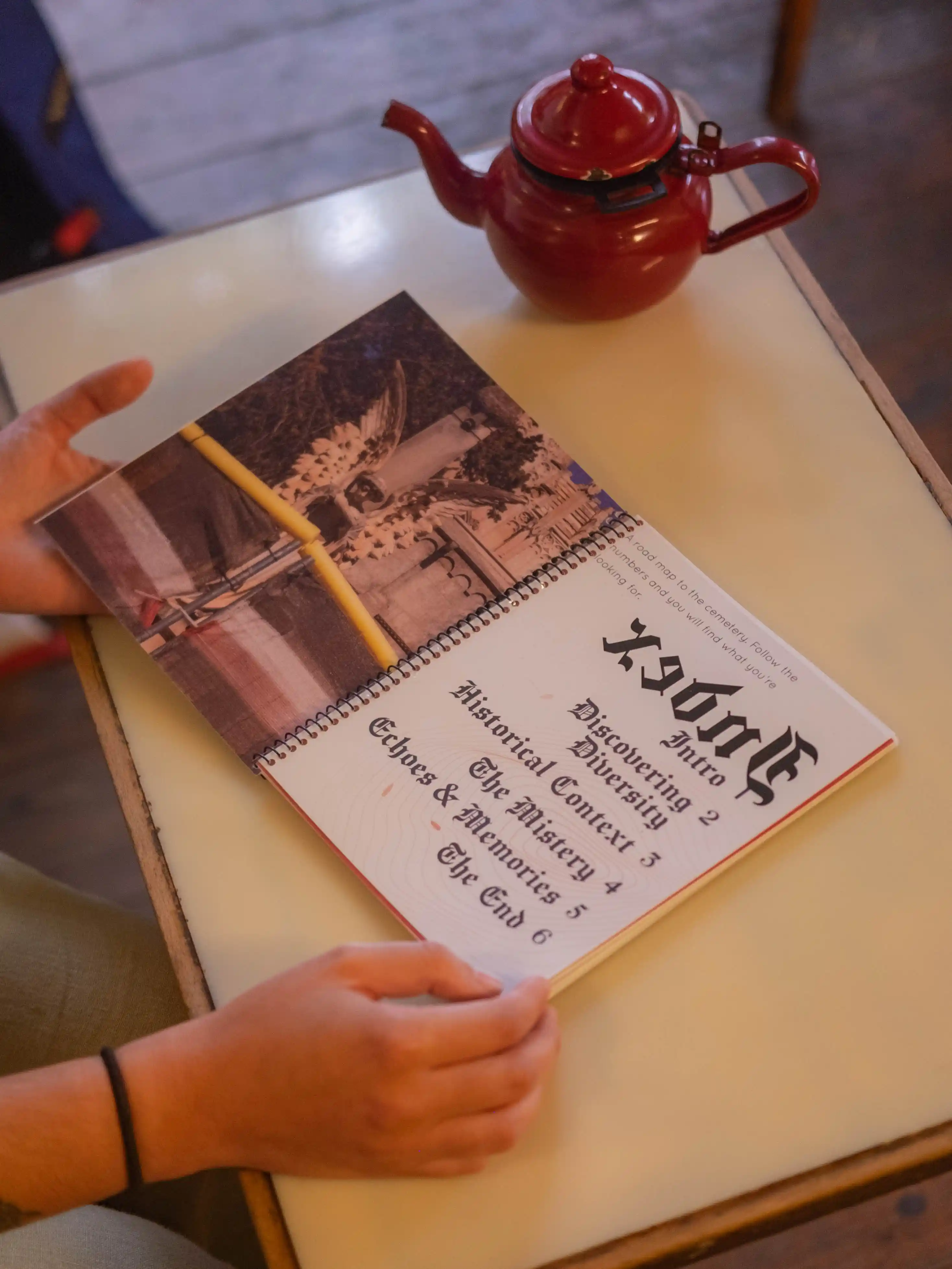 Reader holding the book open at the blackletter index page