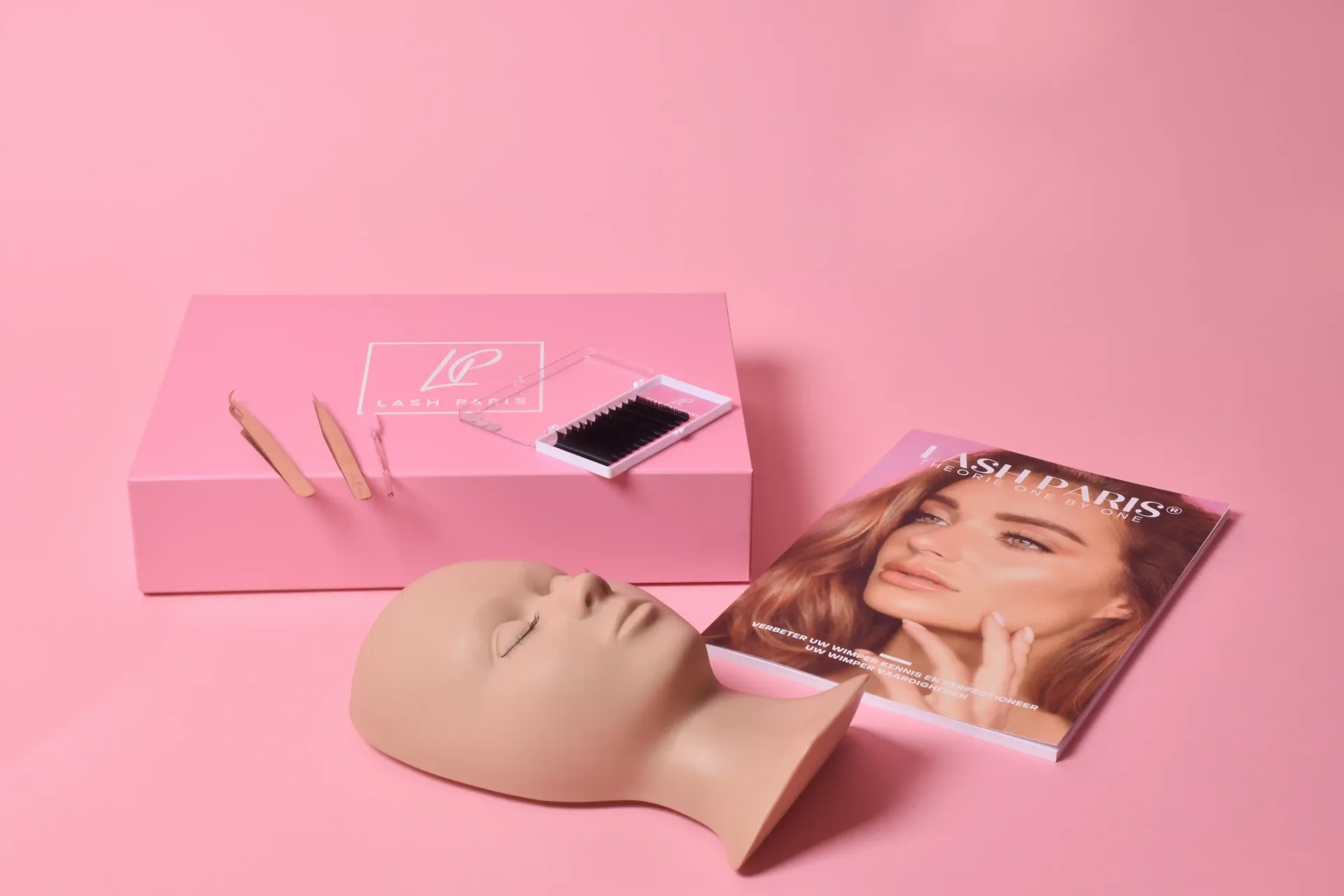 Lash Paris training kit: pink logo box with tweezers and lash tray, practice mannequin head, and theory booklet